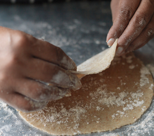 Chef at Prashad delicately rolling a chapati